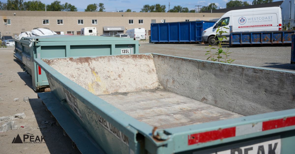 Empty Peak Disposal roll-off bins sit at a yard, suitable for dense excavated soil hauling.